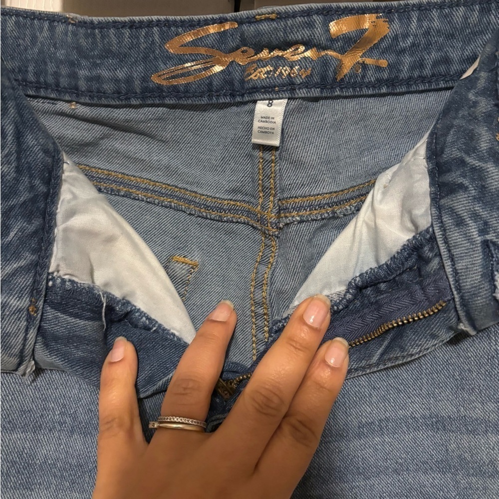 Seven7 Light Blue Slim Flare Jeans with Distressed Accents.
